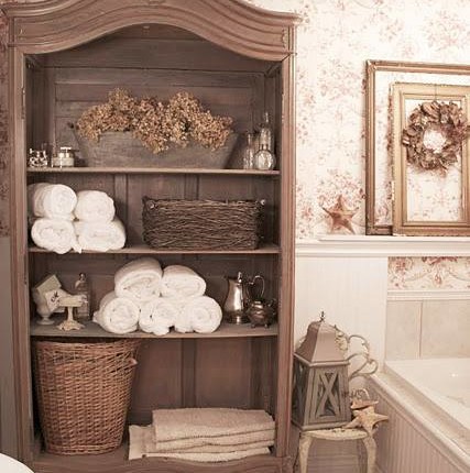 This old armoire was repurposed for towel and bath product storage!…