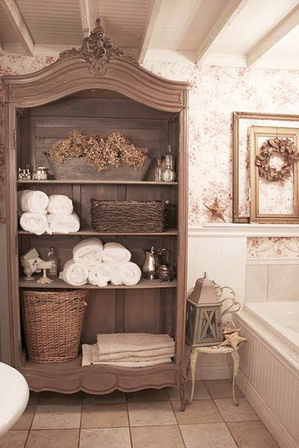 This old armoire was repurposed for towel and bath product storage!…