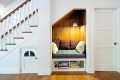 This cozy nook under the stairs looks like the perfect place to enjoy your favor…