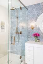 In a mostly white bathroom, this patterned tile really adds a nice pop!…